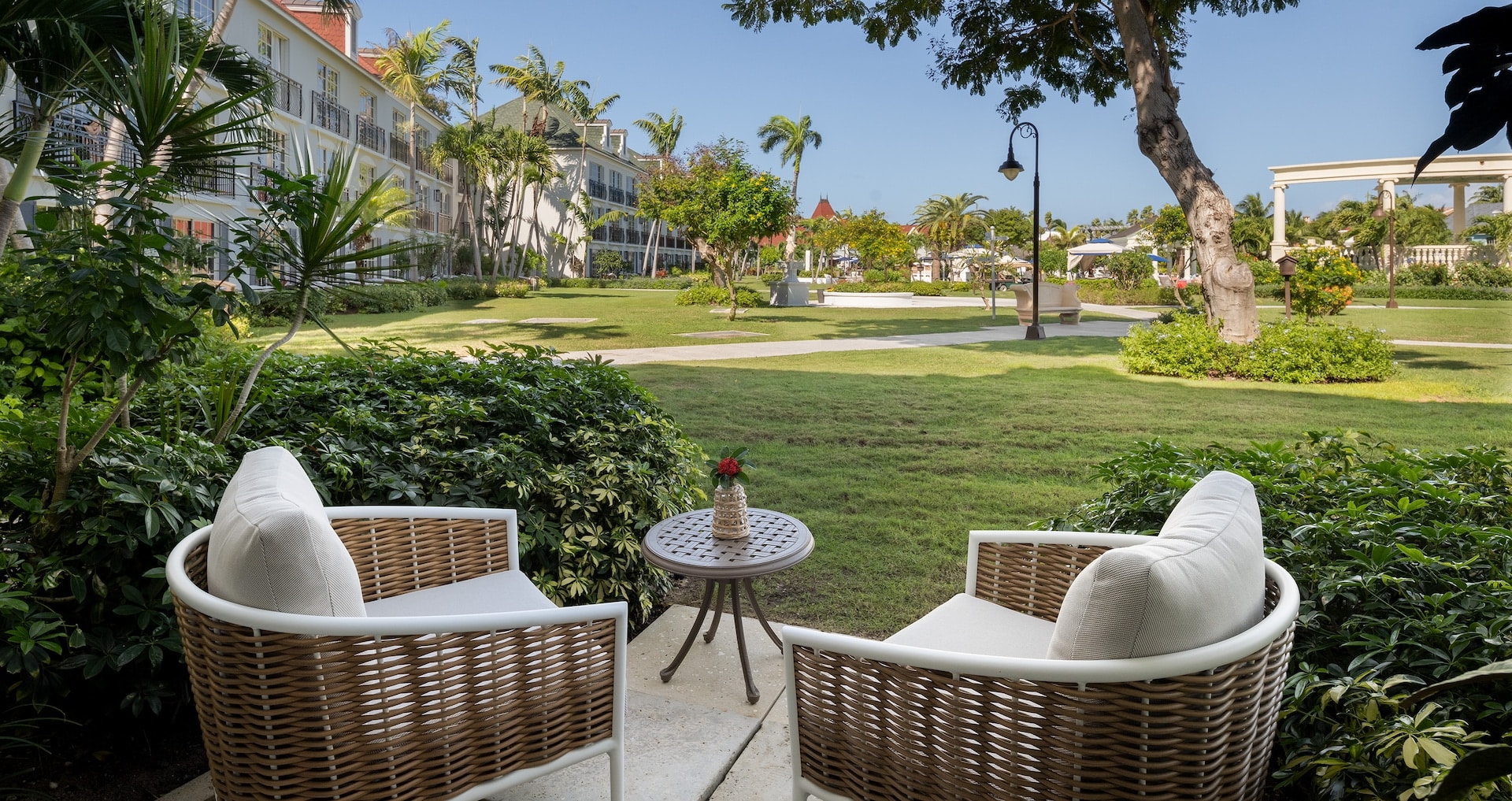 view of the balcony overlooking the gardens and main pool from inside the French Village Three Bedroom Concierge Suite