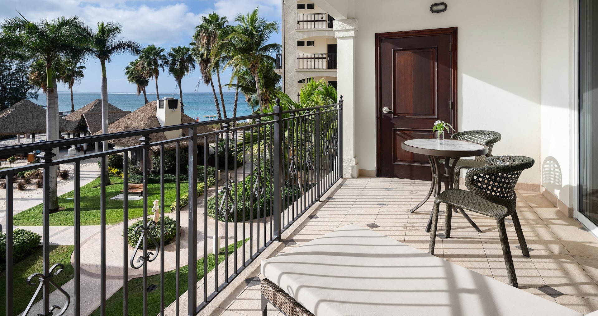 view of the balcony over looking the Italian village pool from inside the Italian Oceanview Two Bedroom Butler Family Suite